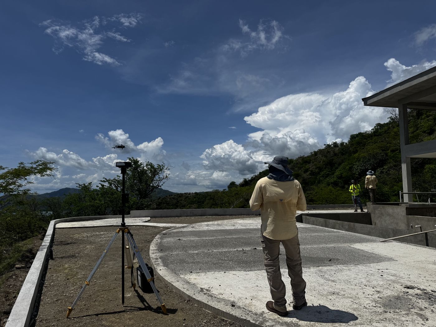 Layout work on a concrete slab at a hillside construction site